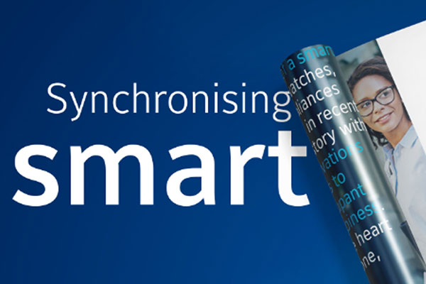 Two magazines with one half-rolled and text that reads 'Synchronizing Smart, Download Now'