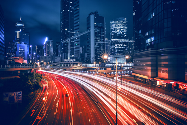 Motion-blur shot of a city highway amidst corporate office buildings
