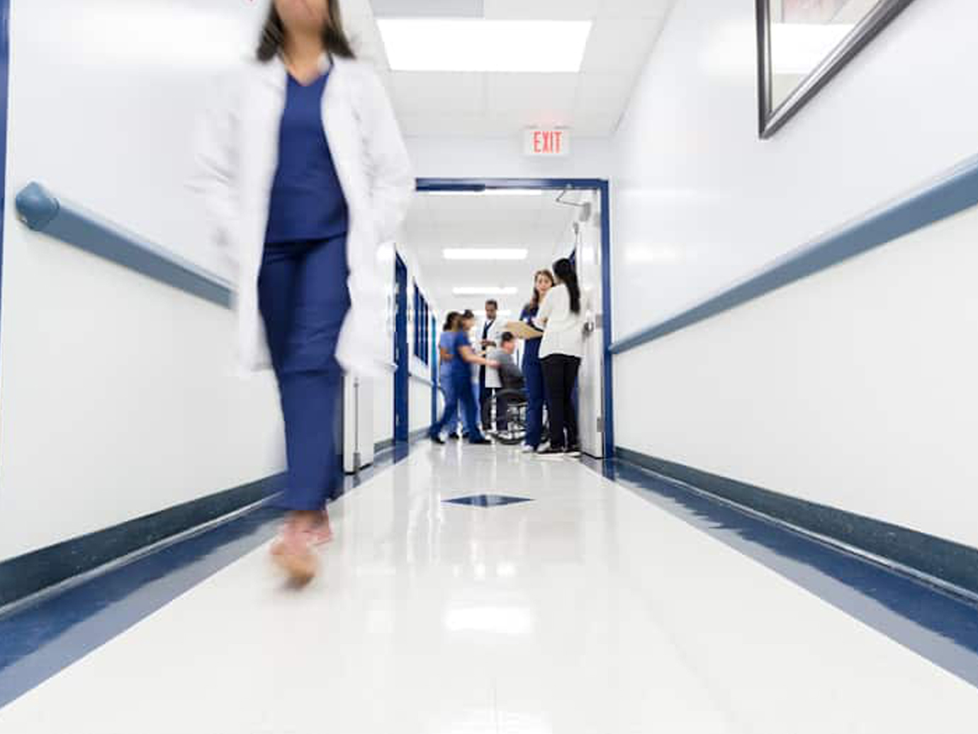 Doctors and nurses walking in a hospital passageway