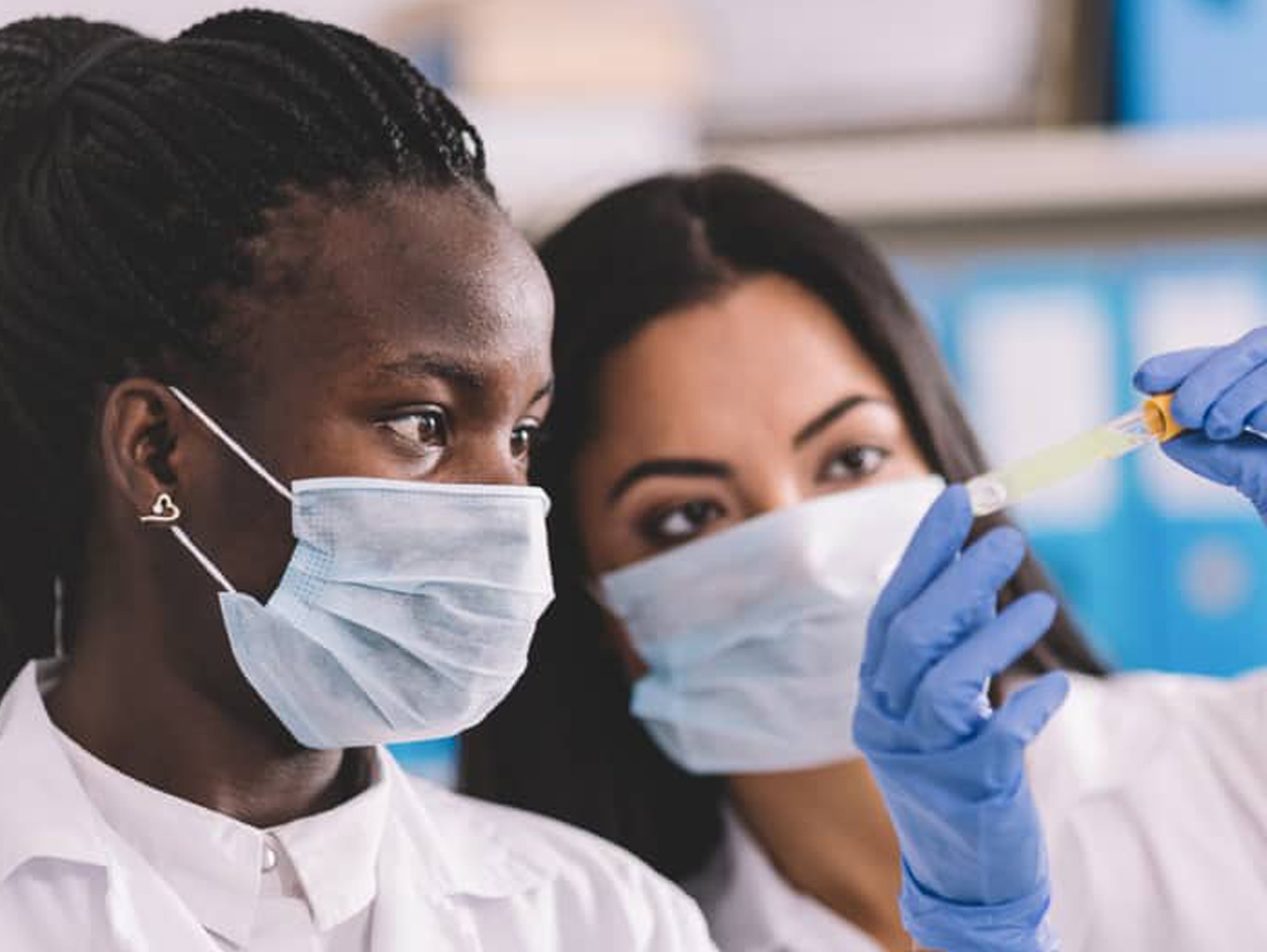 Medical specialists examining a chemical in a test tube