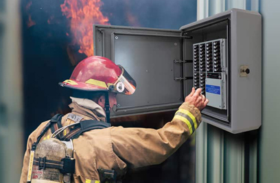 Fire fighter operating a control panel during an emergency