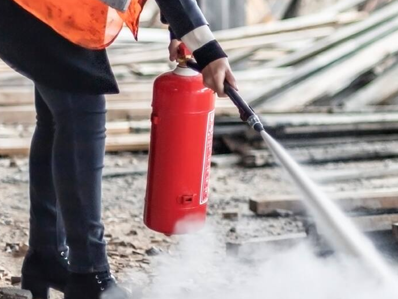Maintenance worker operating a fire extinguisher