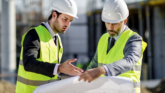 two maintenance workers examining a chart