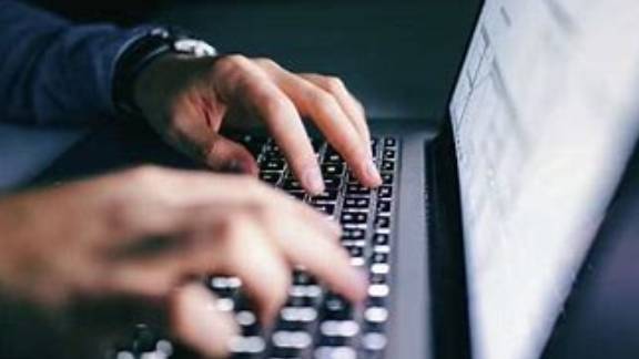 A person typing on a keyboard