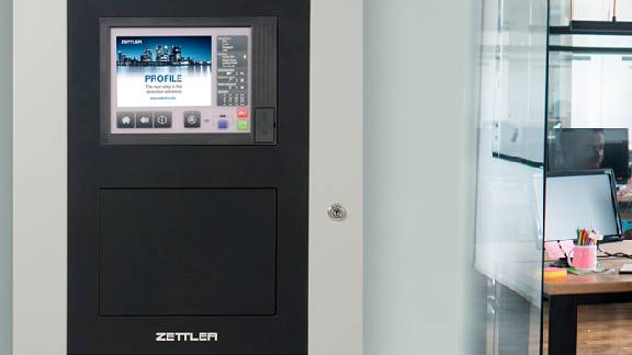 A fire control panel attached to a wall in an office