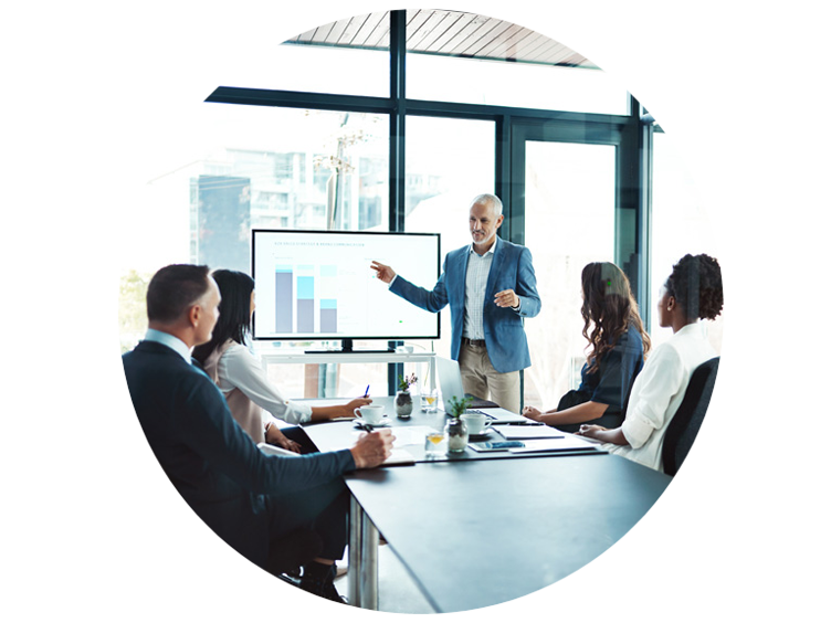 Man demonstrating a presentation with a graph to his coworkers in a conference room