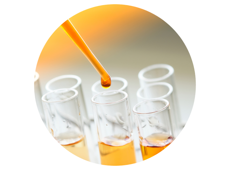 Dropper pouring synthetic oil into test tubes