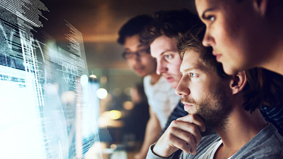 Four people concentrating on a holographic screen