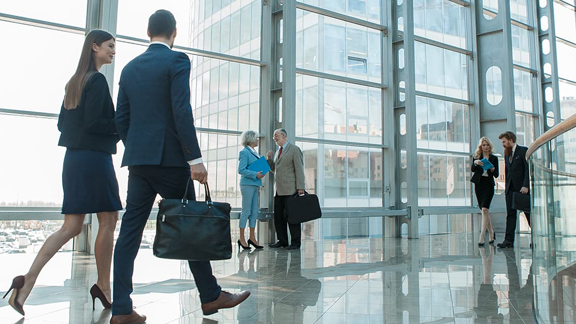 Business people walking in an office lobby