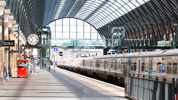 An empty railway platform with train passing through
