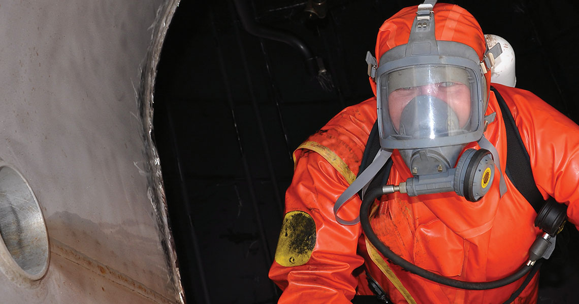 A man in an orange biohazard suit