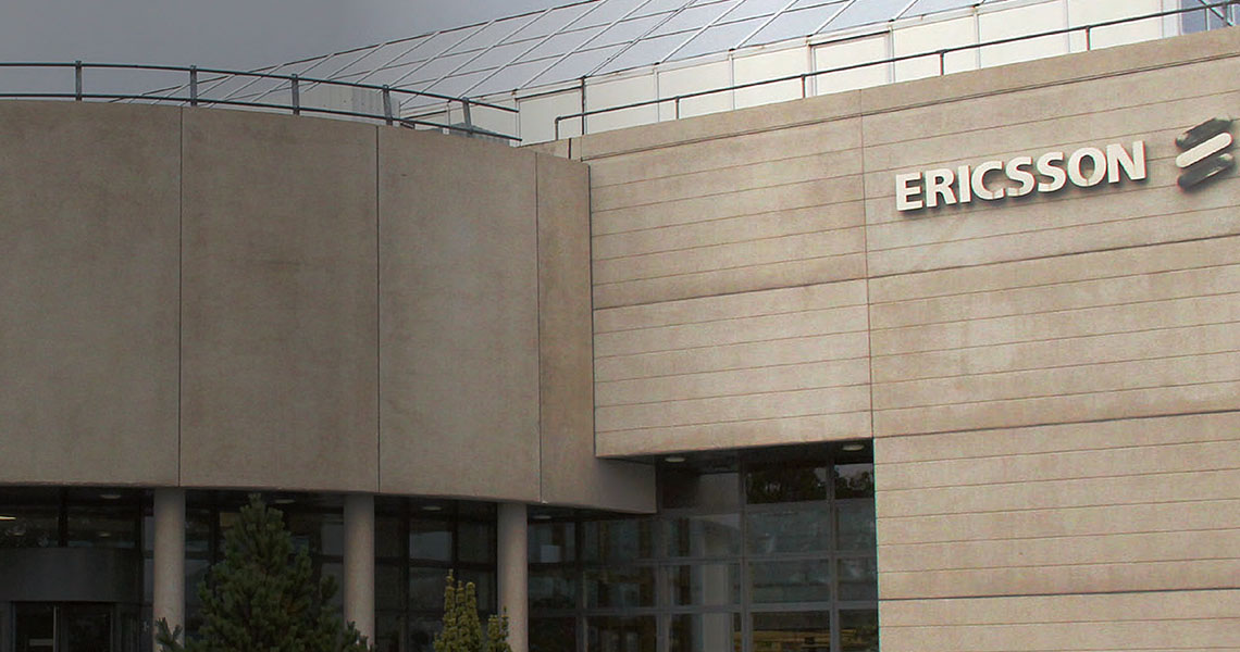 Outside an office building with the Ericsson logo
