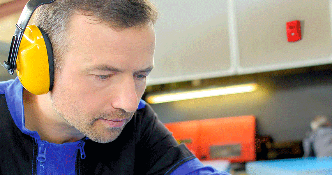 A man wearing headphones looking down