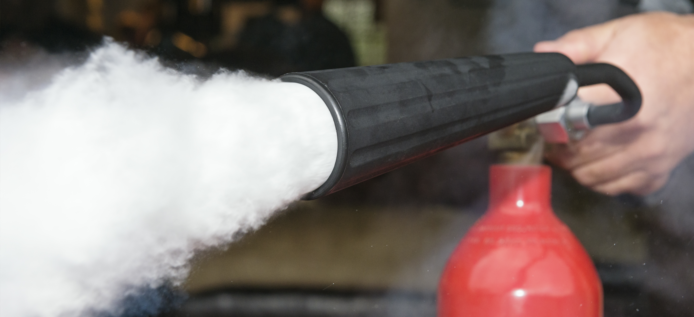 Carbon dioxide shooting out of a fire extinguisher nozzle