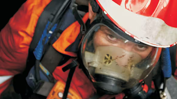 Worker climbing down confined space