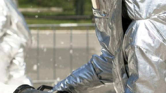 Workers dressed in chemical suits