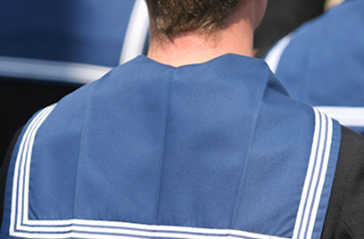 Rear view of a man wearing a blue sailor neckerchief