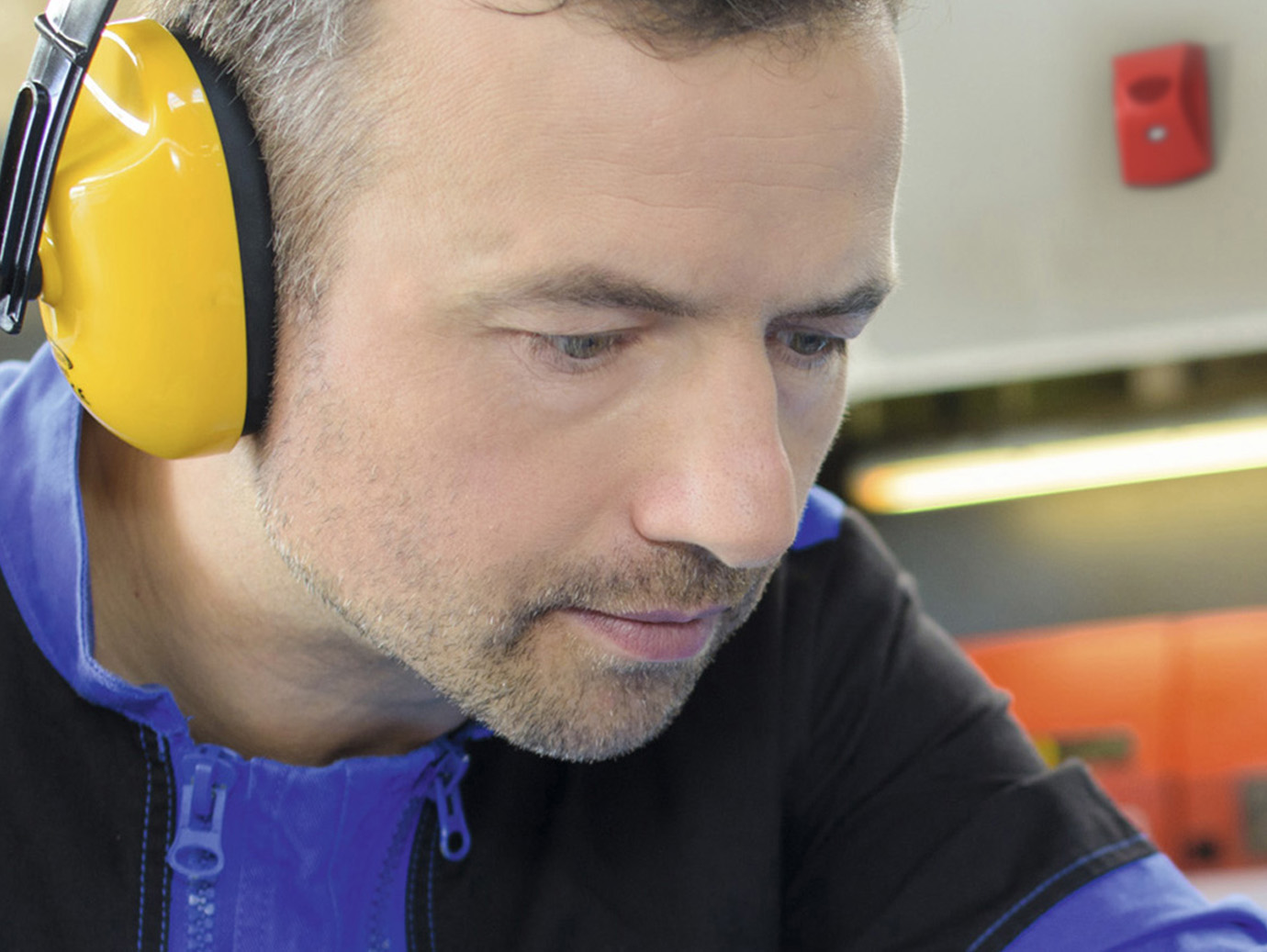 Close up of a man wearing yellow headphones