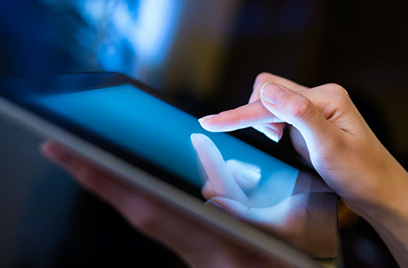 Close-up of a woman using a tablet
