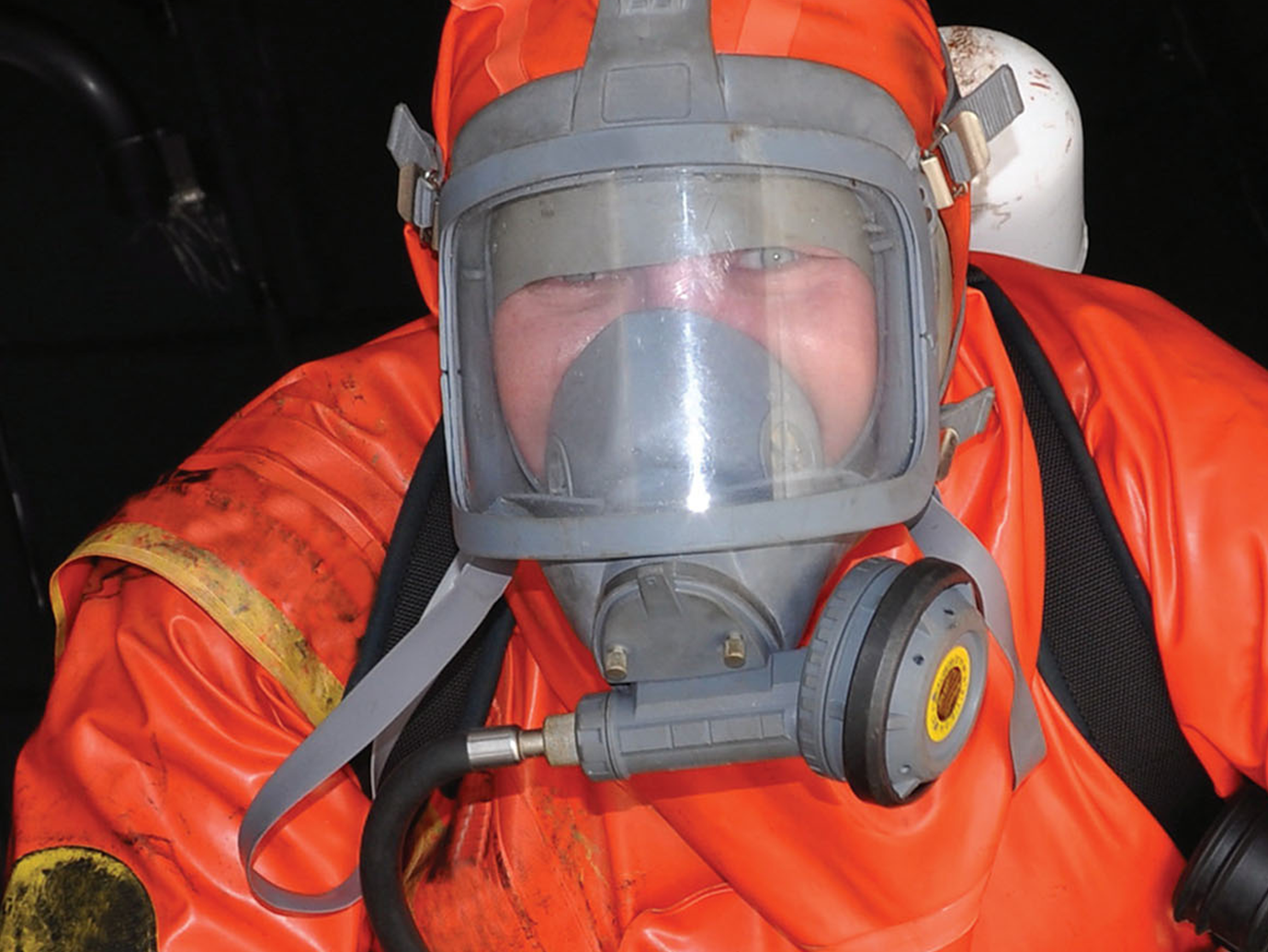 Protective suits and masks with filters for production and construction in store isolated.