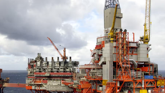 Oil rigs operating cloudy day.