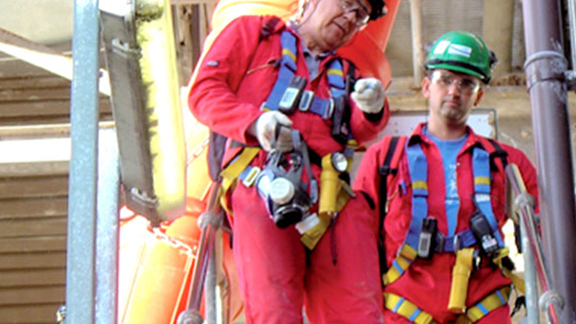 Portrait of two male engineers with full body harnesses.