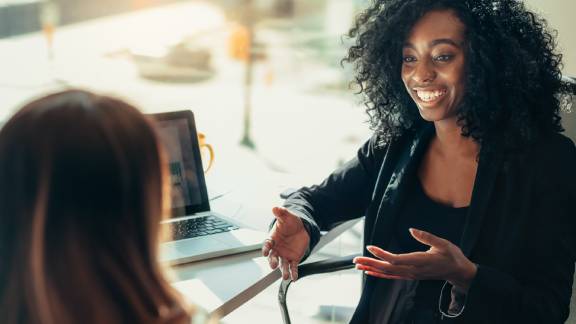 Two womans discussing future goals.