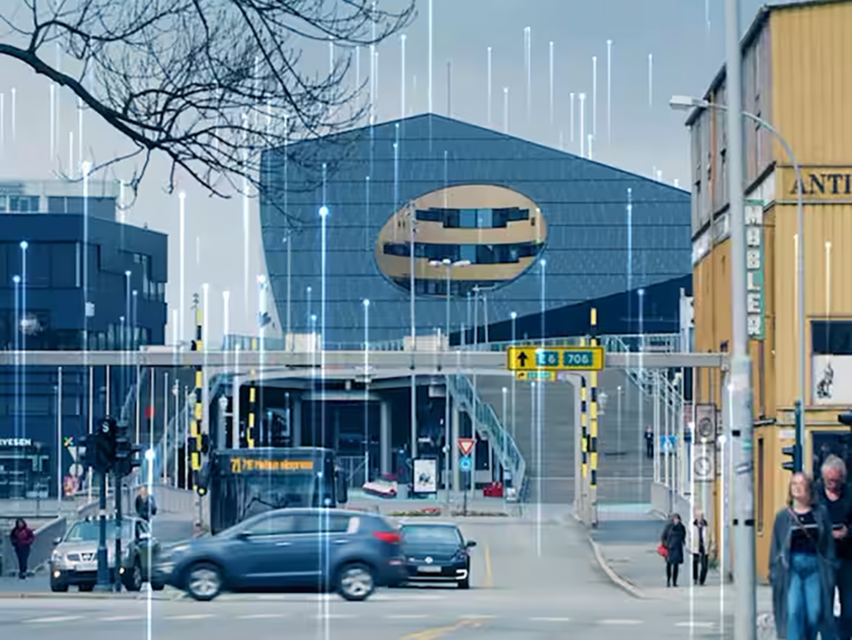 Street in front of the Powerhouse Brattørkaia in Trondheim, Norway, overlaid with a graphic of transmission nodes