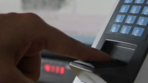 A person scanning his fingerprint on a biometric scanner