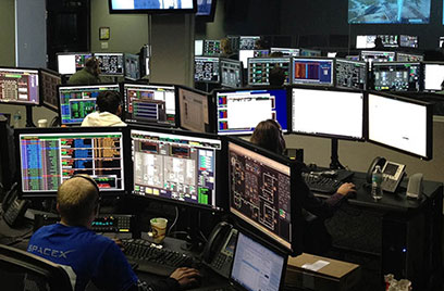 people working on monitors