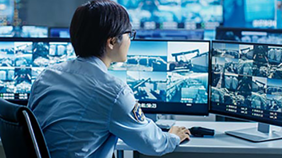 A security guard examining footage of video surveillance