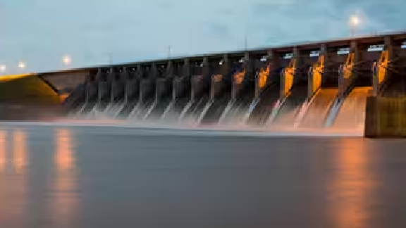 Water rushing out of the open gates of a dam