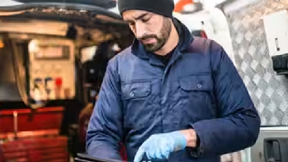 Technician in uniform working on a tablet
