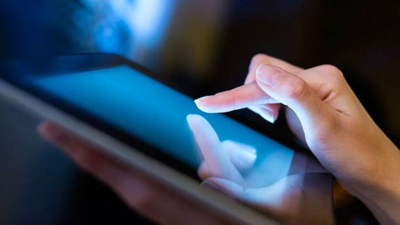 Close up of a person using  a tablet