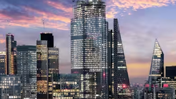 High-rise buildings lit up in the evening