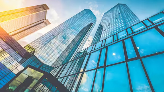 Upwards shot of glass buildings against the sky