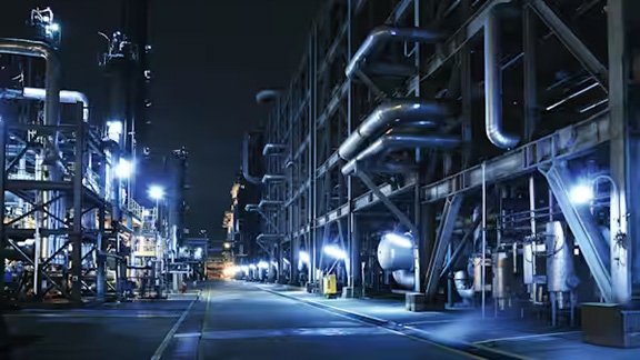 An industrial piping system at night time
