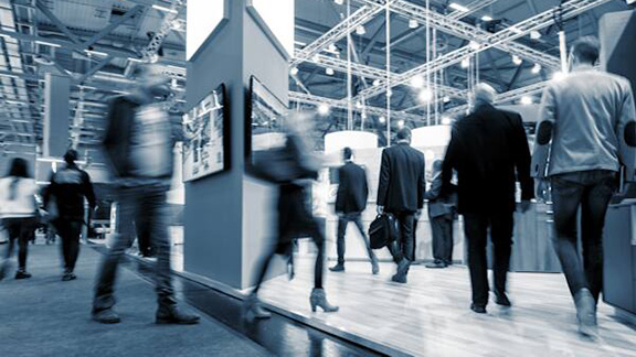 Motion-blur shot of people walking at an exhibition