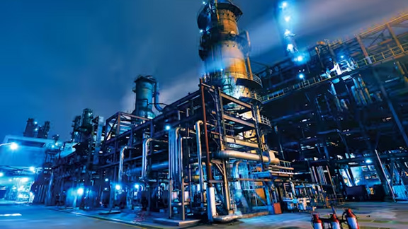 Piping system at a factory at night