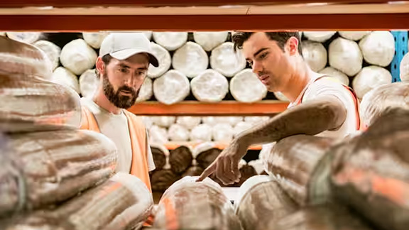 Two men in discussion in a warehouse