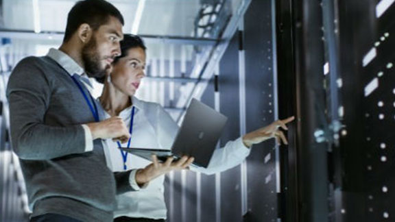 Couple with laptop at data center