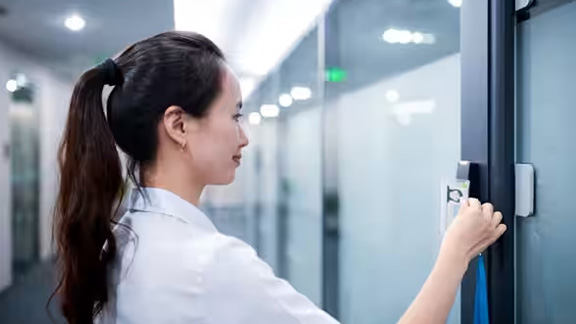 Woman scanning her identity card on an access control device
