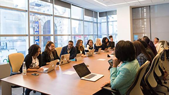 Employees seated a table for a meeting