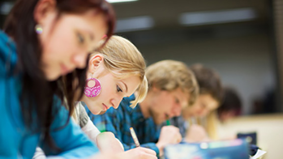 A row of students taking an exam