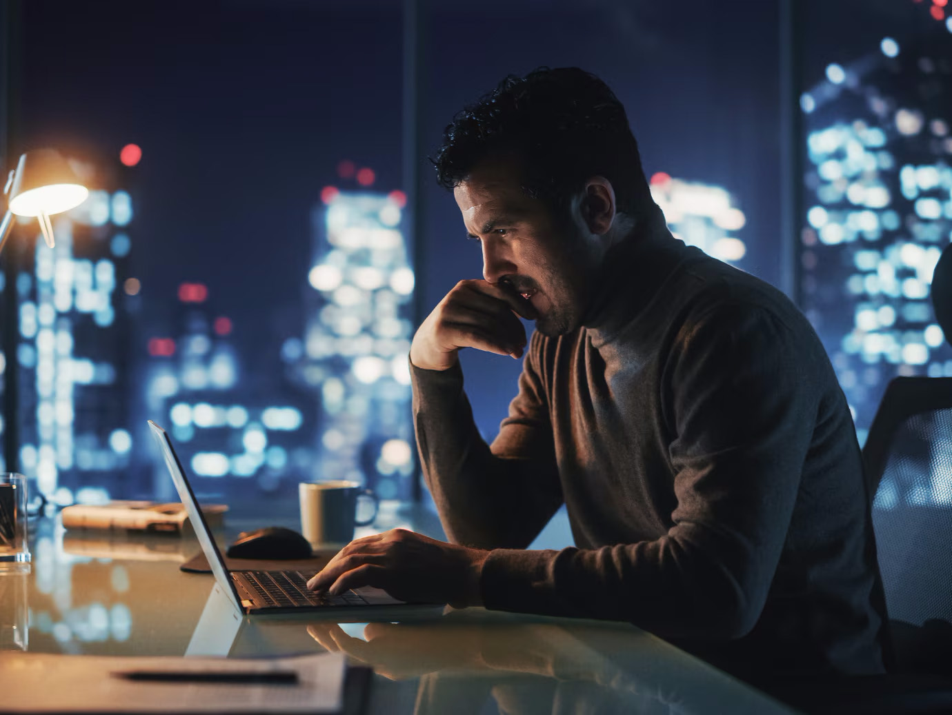 A person sitting at a desk with a laptop