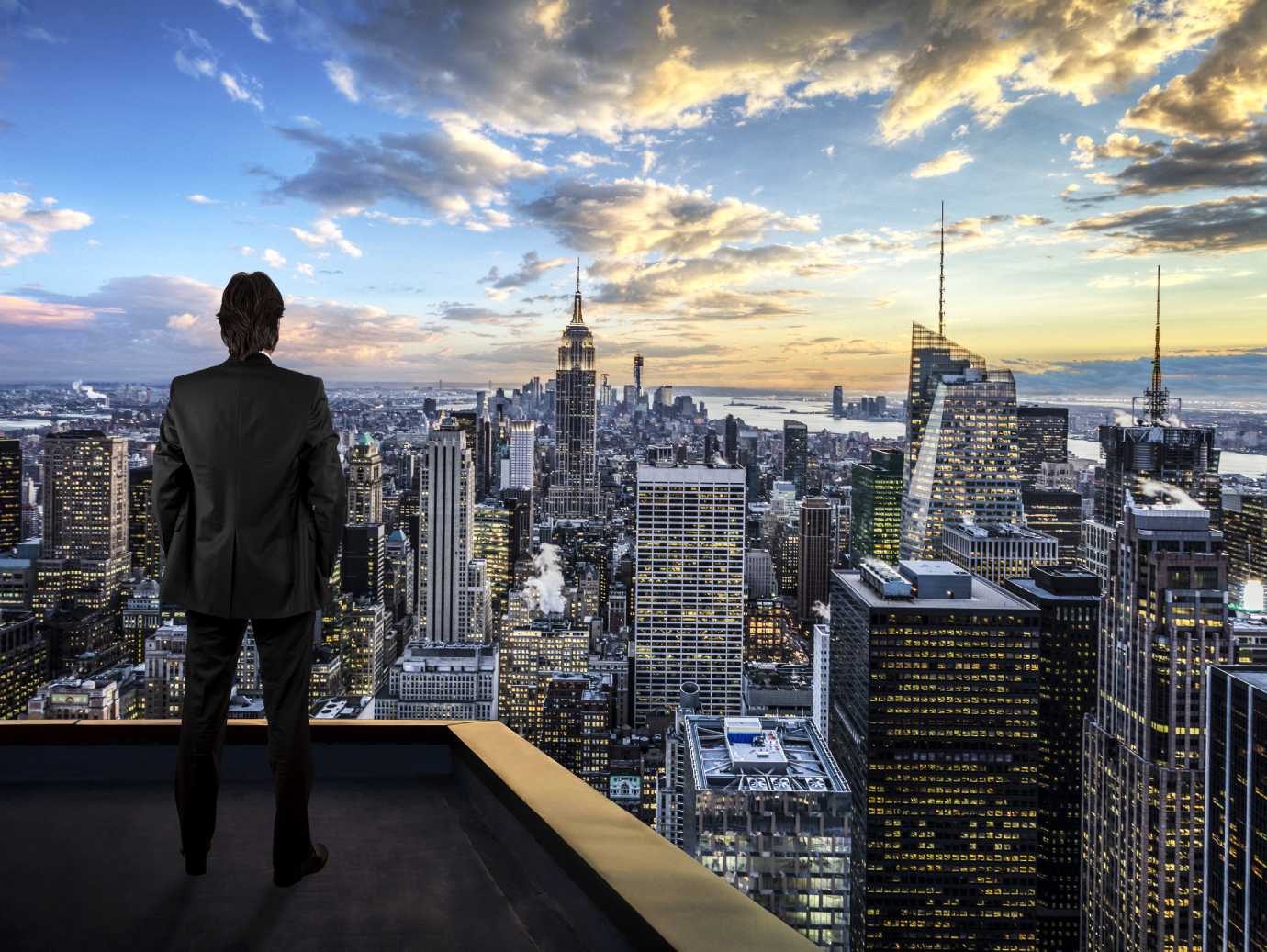 A person standing on a rooftop overlooking a city
