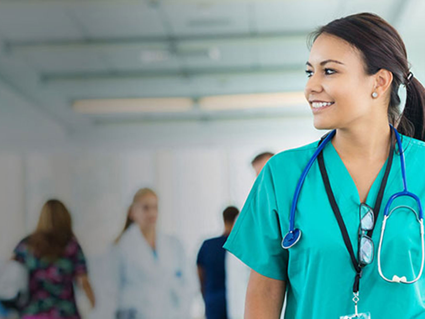 nurse smiling and walking in corridor
