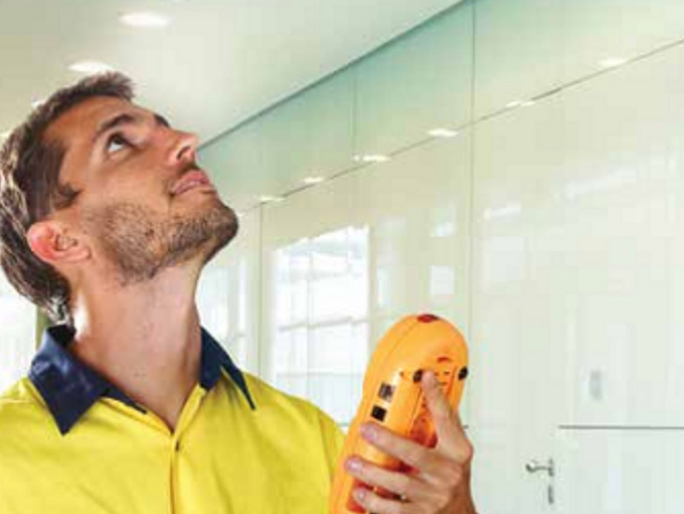 maintenance worker holding fire detection equipment