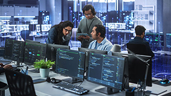 Employees discussing work in a control room, overlaid with a graphic of transmission nodes in the backgroound
