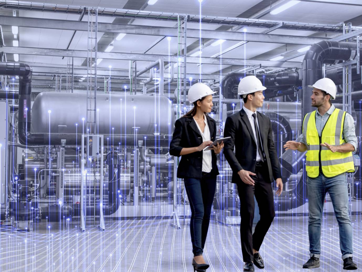Three mechanics in discussion in an industrial facility